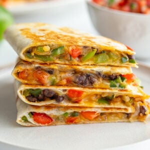 stack of vegetarian quesadillas with bell pepper, onion, cheese, and black beans