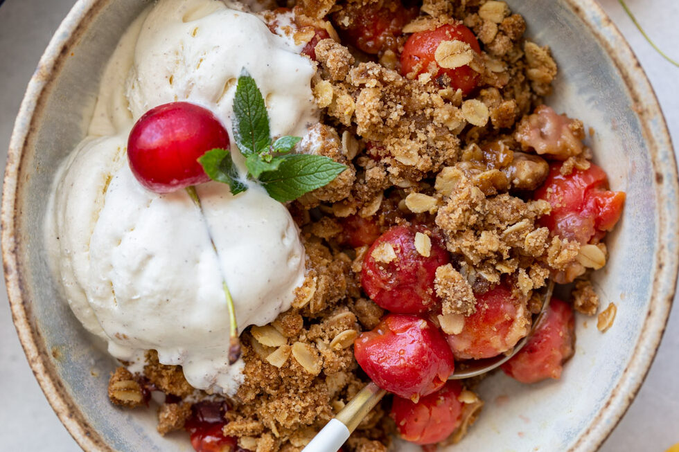 cherry crisp served with vanilla ice cream