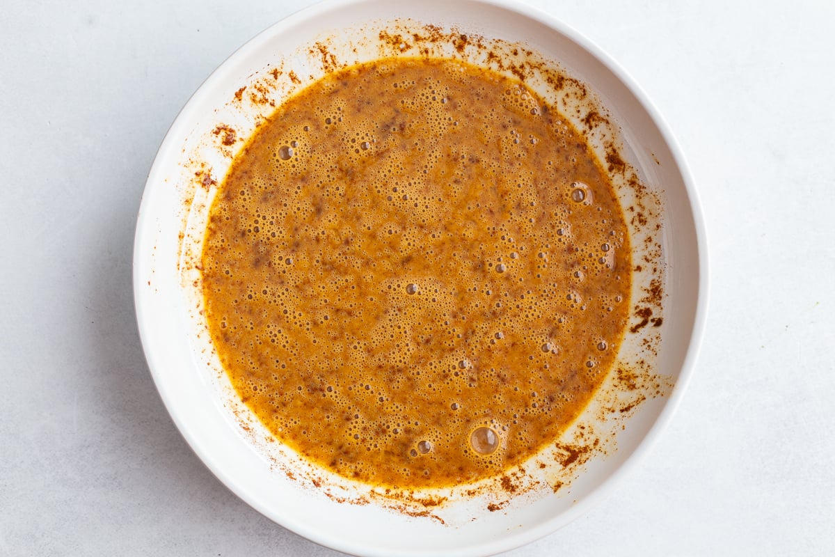 eggs and cinnamon whisked together in a wide bowl to make french toast