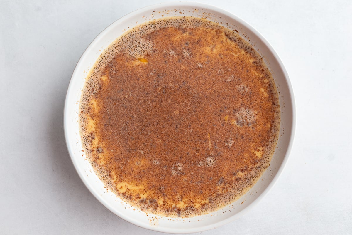 milk, eggs, and spices whisked together in a wide bowl to make french toast