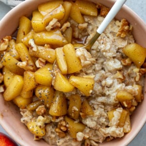 Spoon stirring apple pie oatmeal.