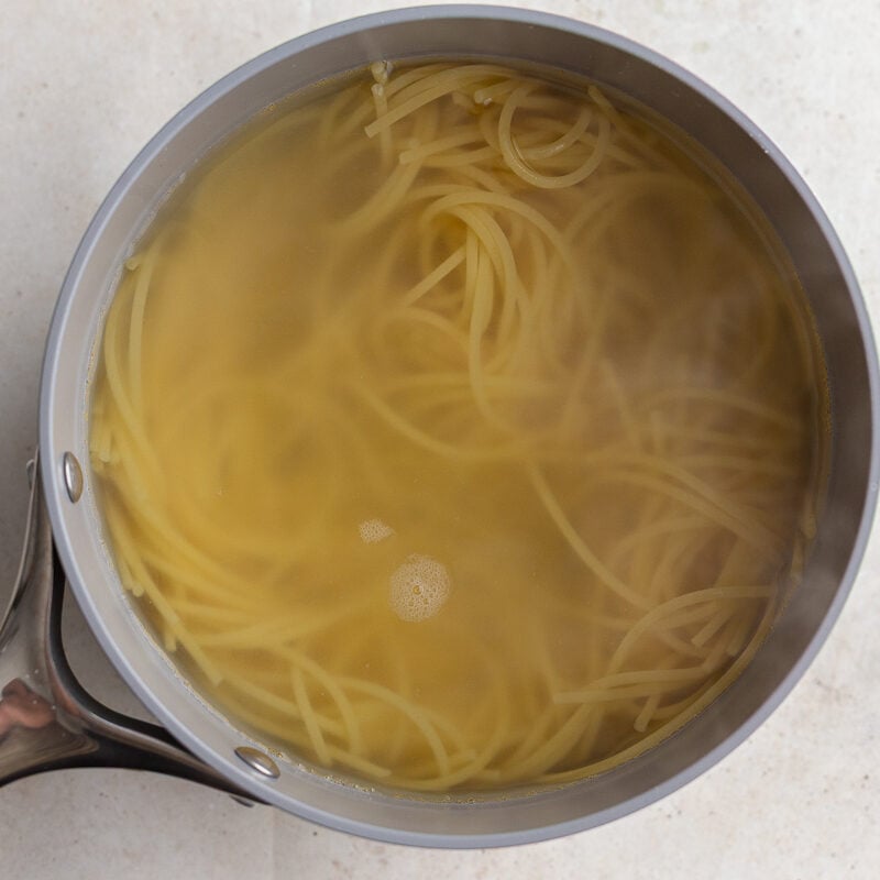 spaghetti cooked in a pot with water