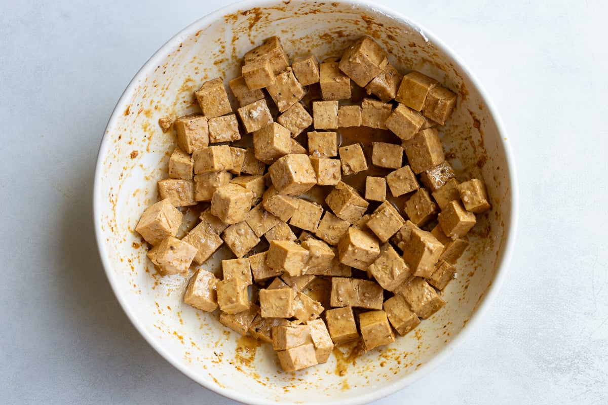 cornstarch covered tofu cubes in a large bowl