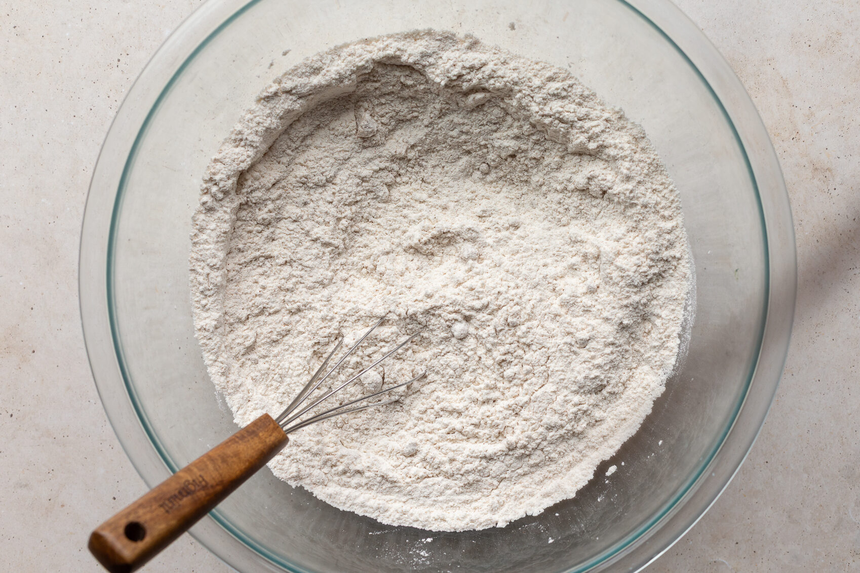 Whisking together flour with baking powder and brown sugar.