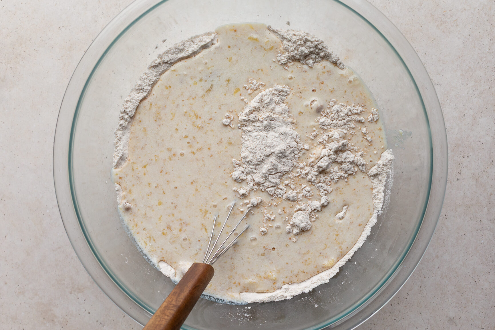 Mixing together the waffle batter in a large bowl.