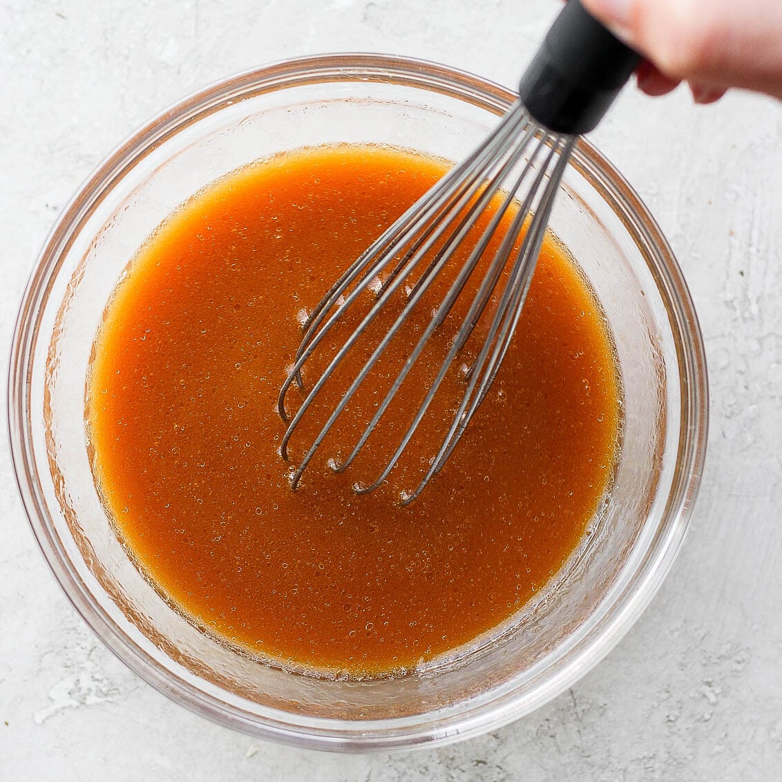 chow mein sauce being whisked in a small bowl