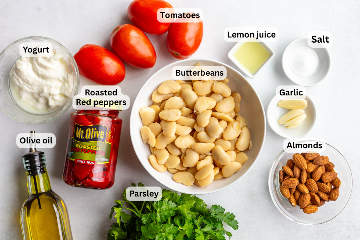 ingredients needed to make romesco butterbeans including butterbeans, roasted red peppers, tomatoes, almonds, salt, herbs, olive oil, etc