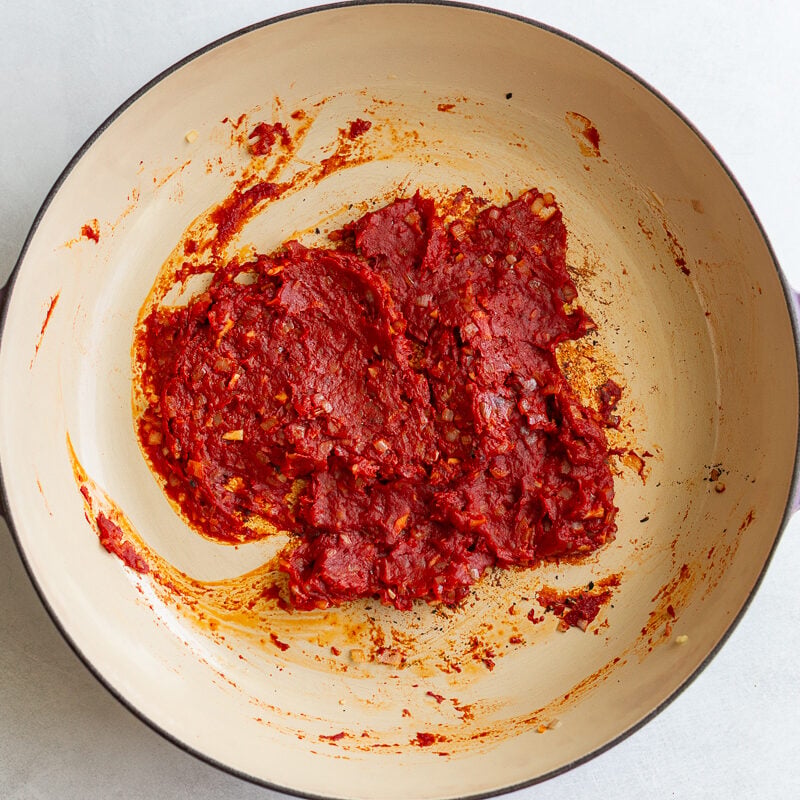 tomato paste and garlic in a large skillet