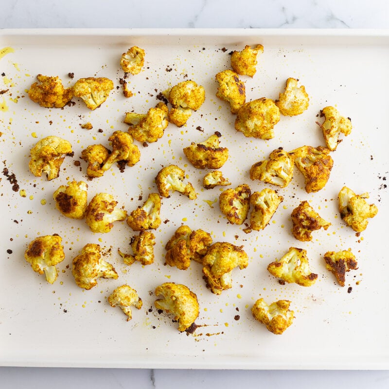 curried cauliflower cooked on a baking sheet