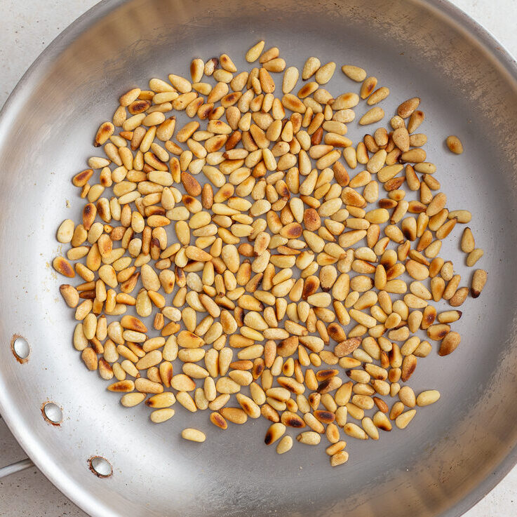 toasted pinenuts in a skillet