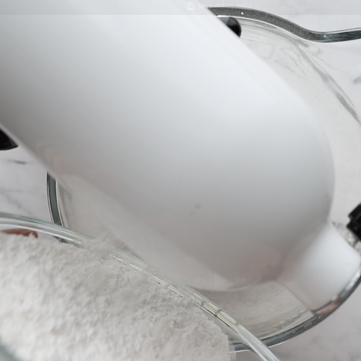 ingredients being added to a white stand mixer from the top