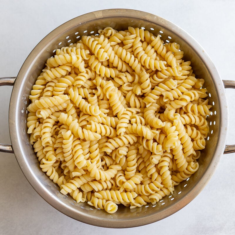 cooked rotini pasta in a colander