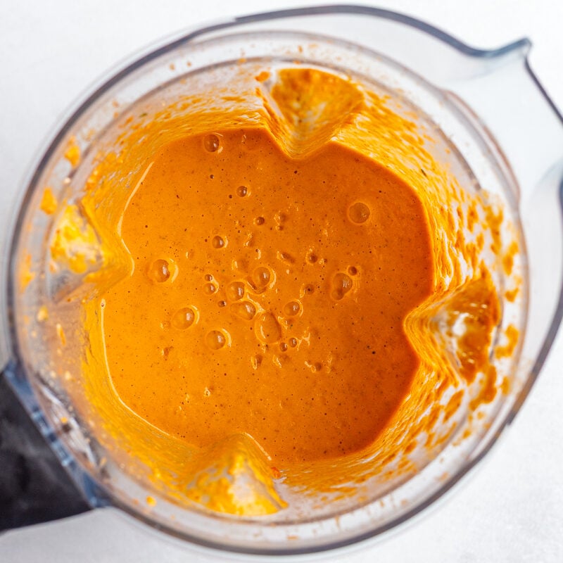 bright orange romesco sauce blended in a blender