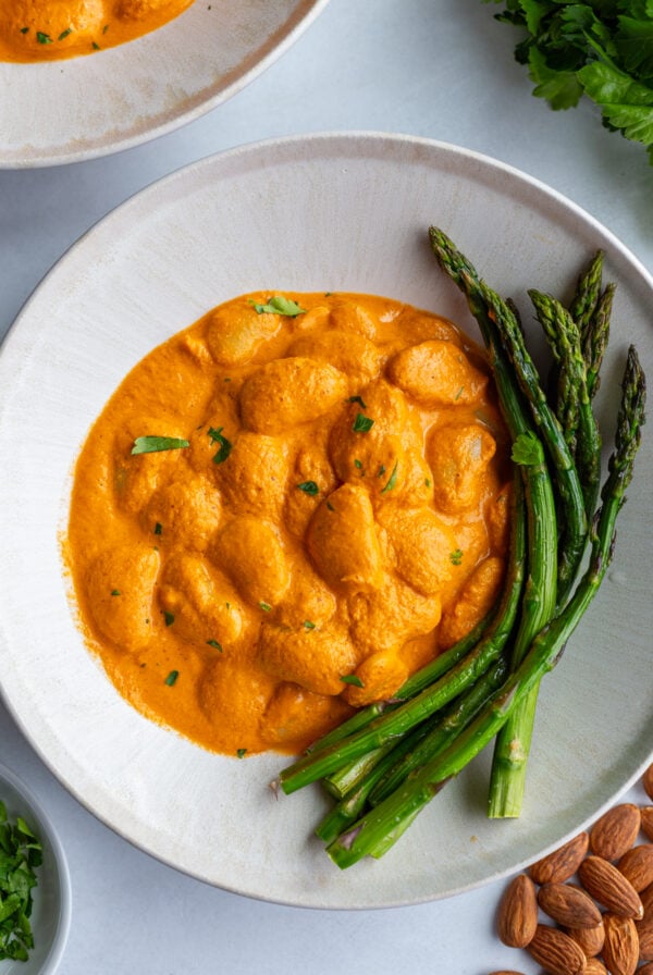 romesco butterbeans in a bowl with asparagus