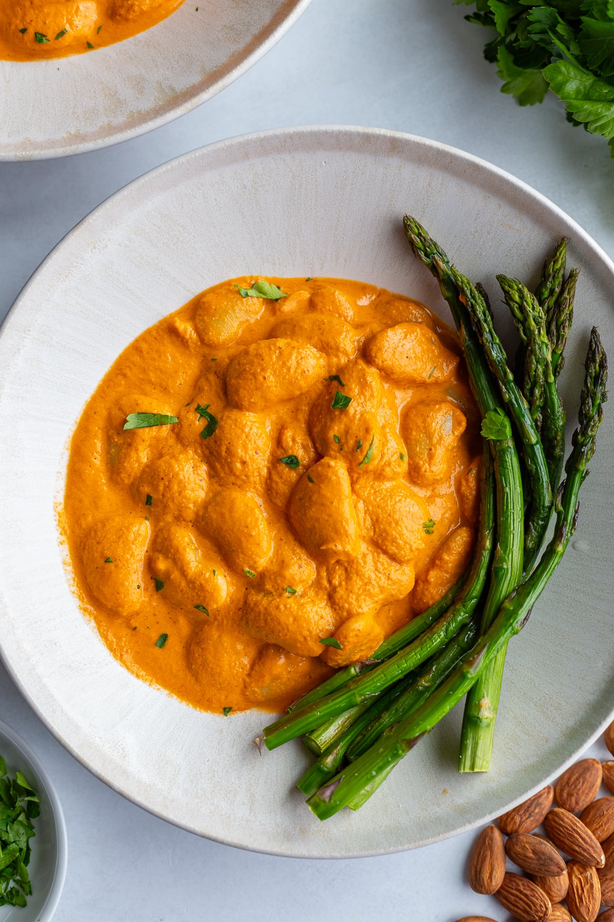 romesco butterbeans in a bowl with asparagus