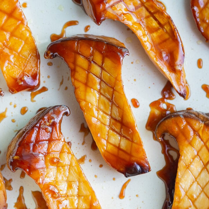 king oyster mushrooms in a skillet cooked with sticky teriyaki sauce