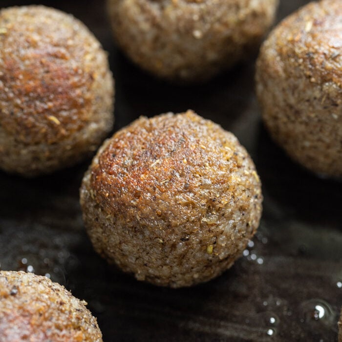 vegan meatballs being cooked in a skillet