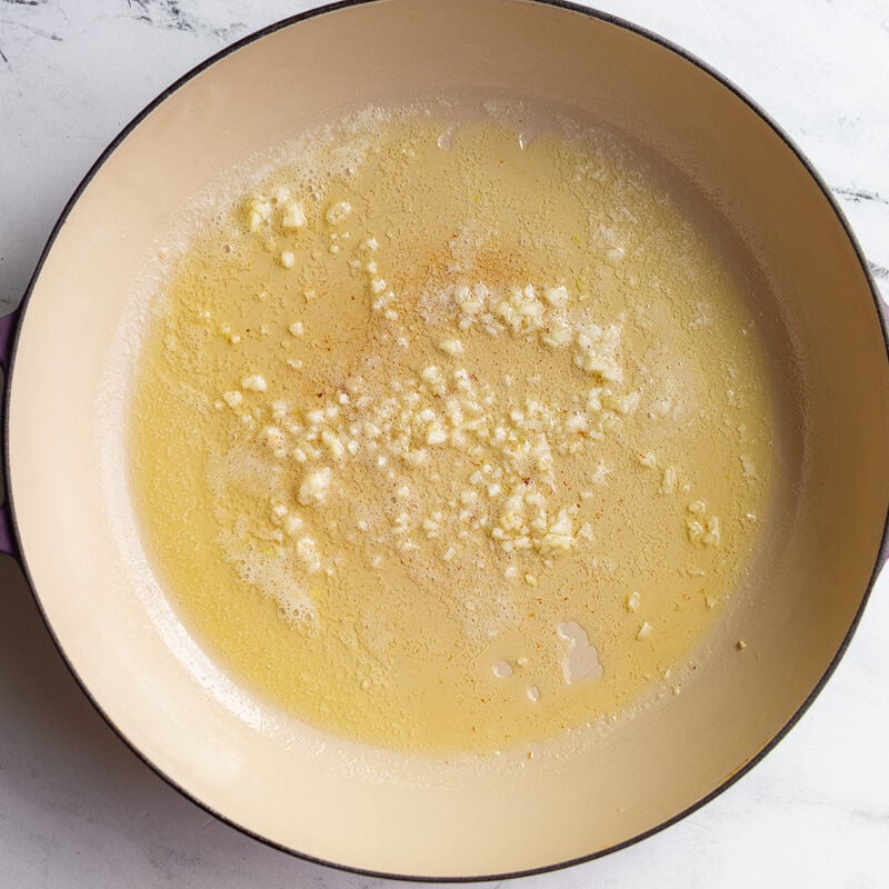 garlic cooking in olive oil in a large skillet