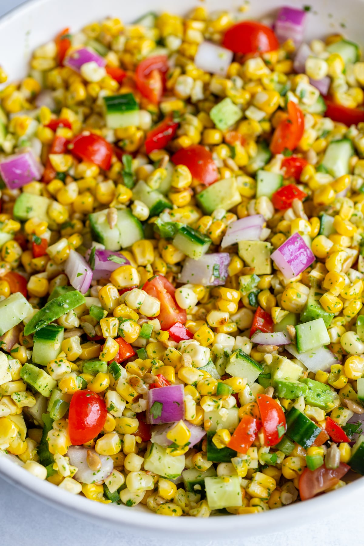 grilled corn salad with fresh veggies in a large white bowl