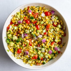 grilled corn salad with fresh veggies in a large white bowl