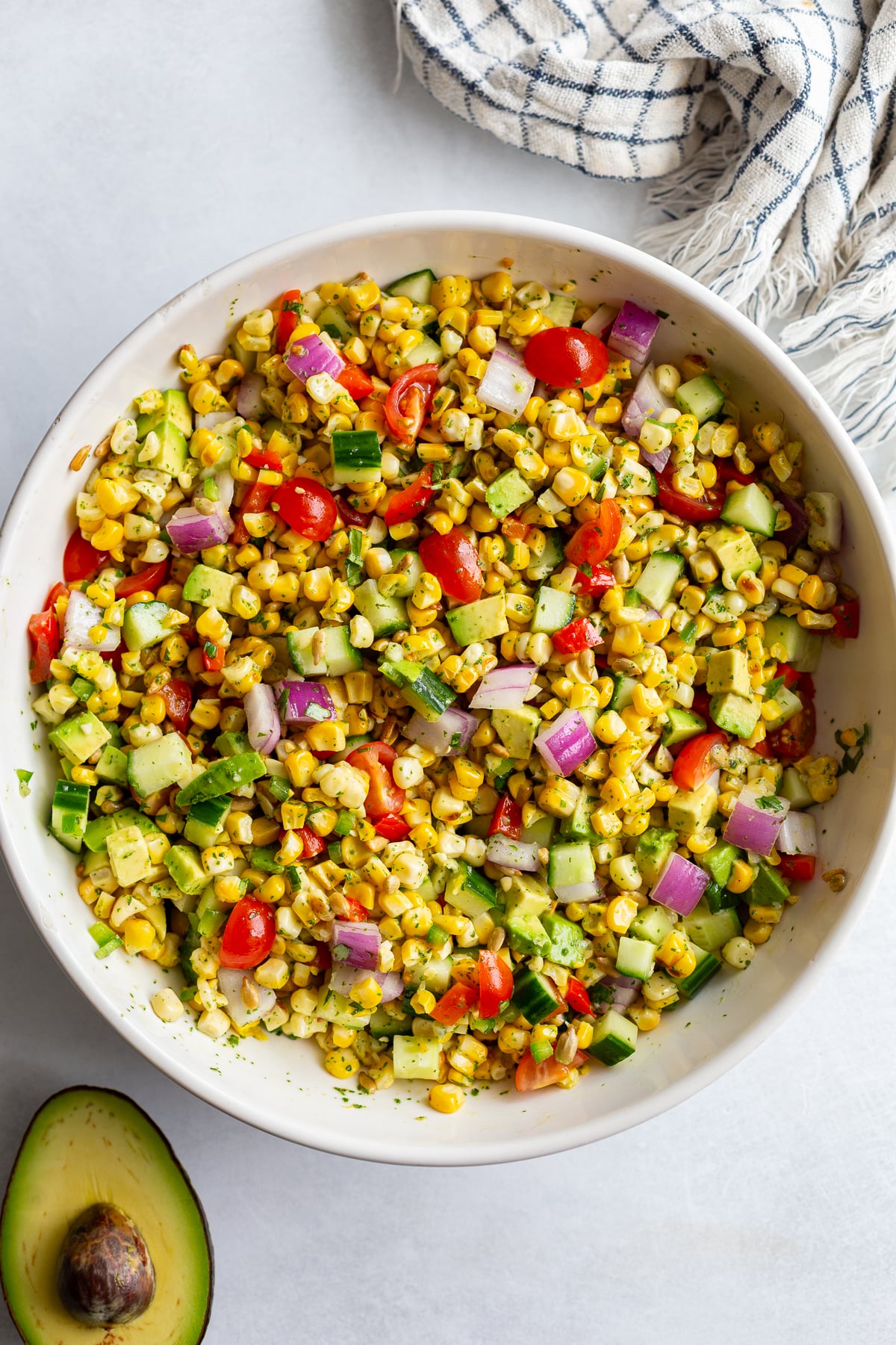 grilled corn salad with fresh veggies in a large white bowl