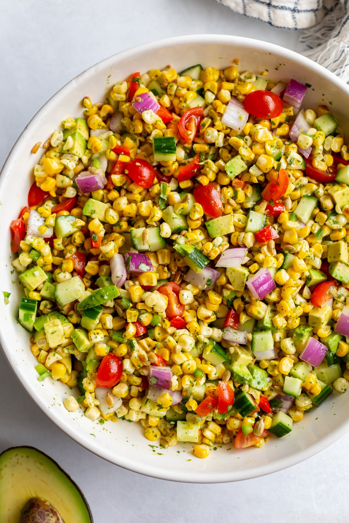 grilled corn salad with fresh veggies in a large white bowl