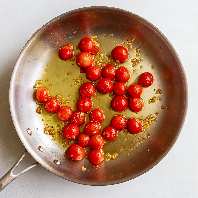 olive oil and cherry tomatoes in a skillet