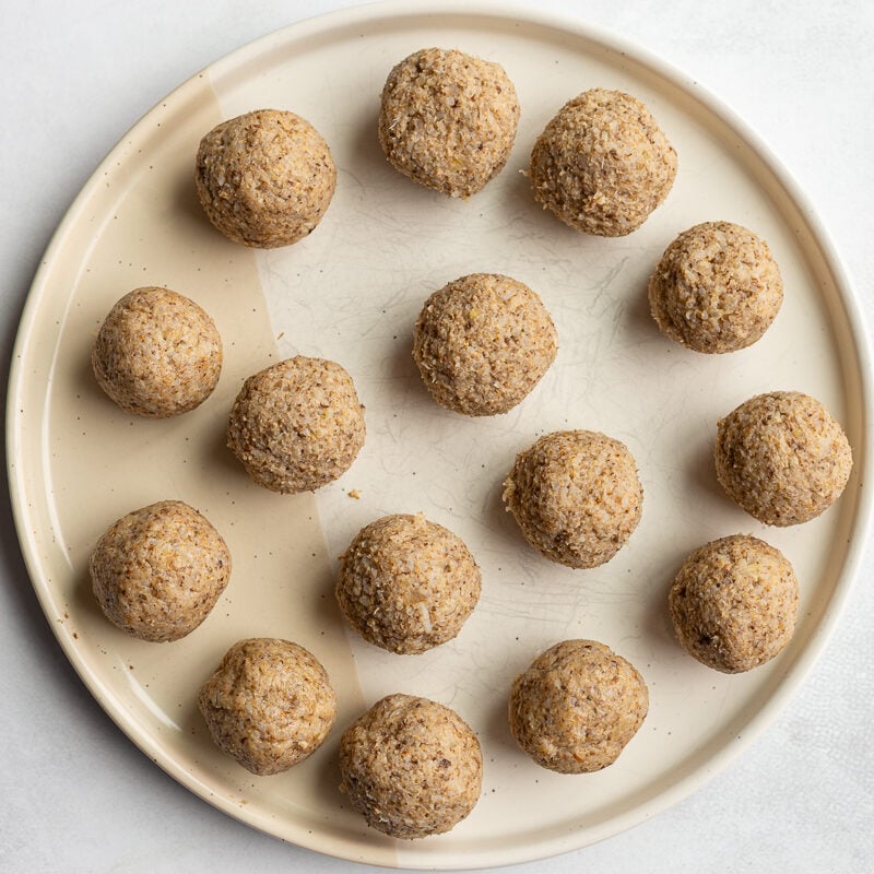 vegan meatballs on a large plate before they've been cooked