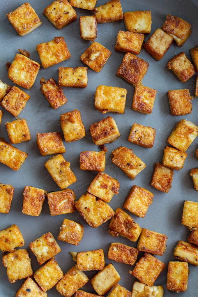 up close shot of crispy tofu in a large skillet