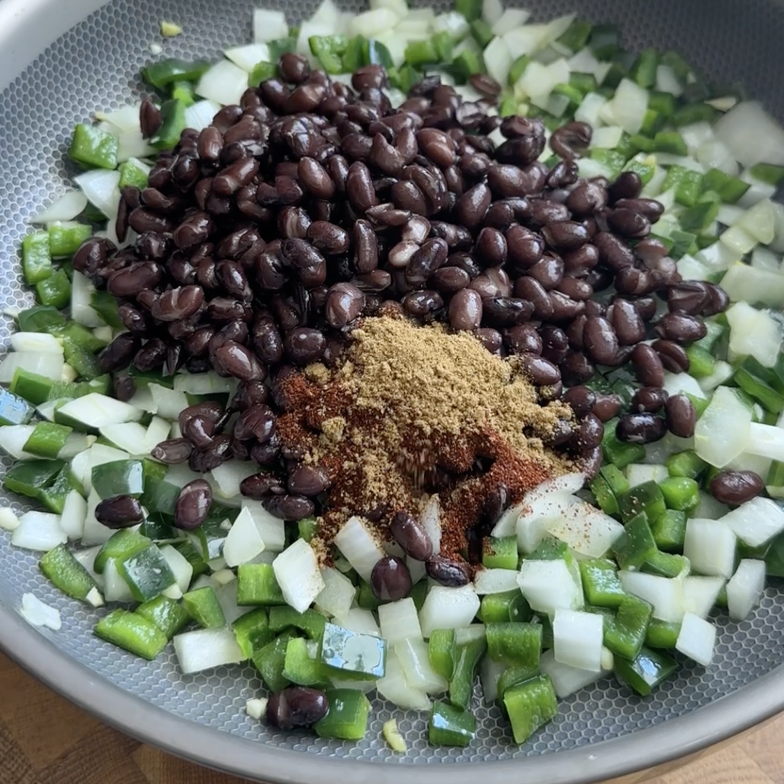onion, pepper, onion, black beans and spices in a large skillet