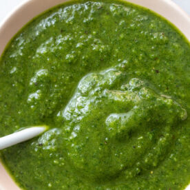 large bowl of vibrant green vegan pesto