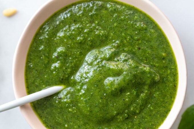 large bowl of vibrant green vegan pesto