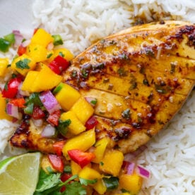 cilantro lime tofu that looks like grilled chicken with a mango salsa on top. all on a bed of rice