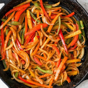 Sautéed bell peppers and onion in a cast iron skillet.