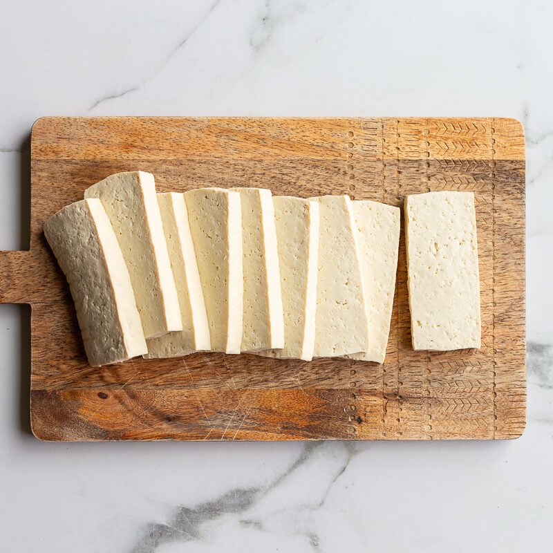 slabs of tofu on a wood cutting board