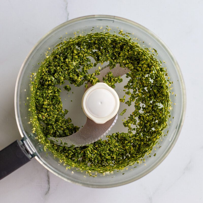 chopped basil, garlic, and pine nuts in a food processor before oil is added