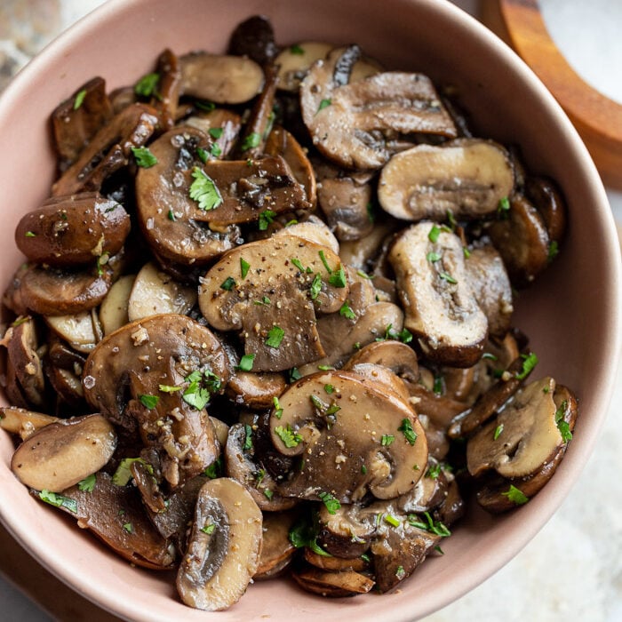 sautéed mushrooms in a pink serving bowl