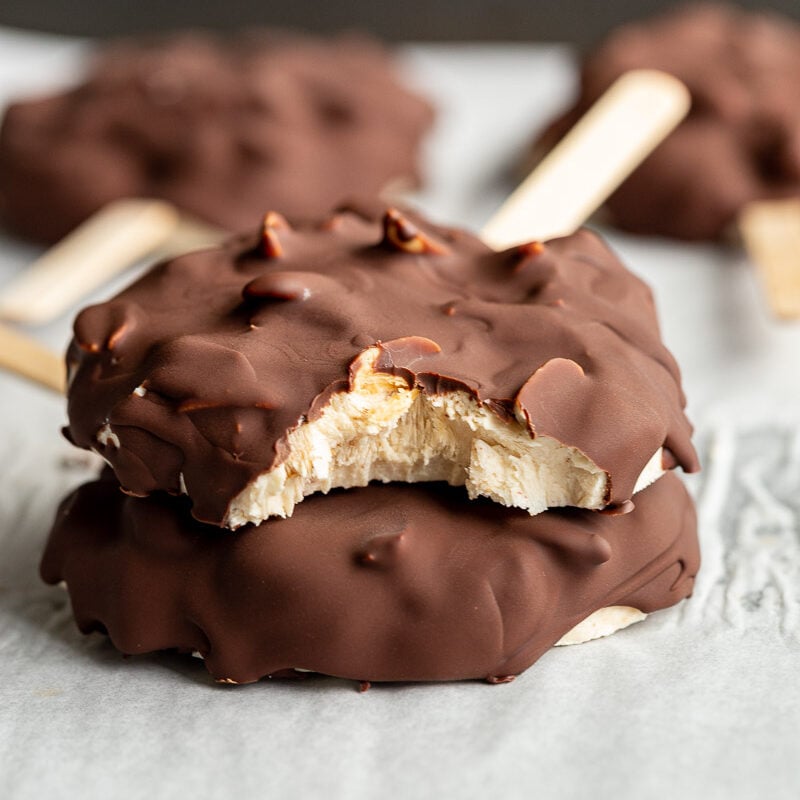 frozen yogurt chocolate bars on a stick with a bite taken out