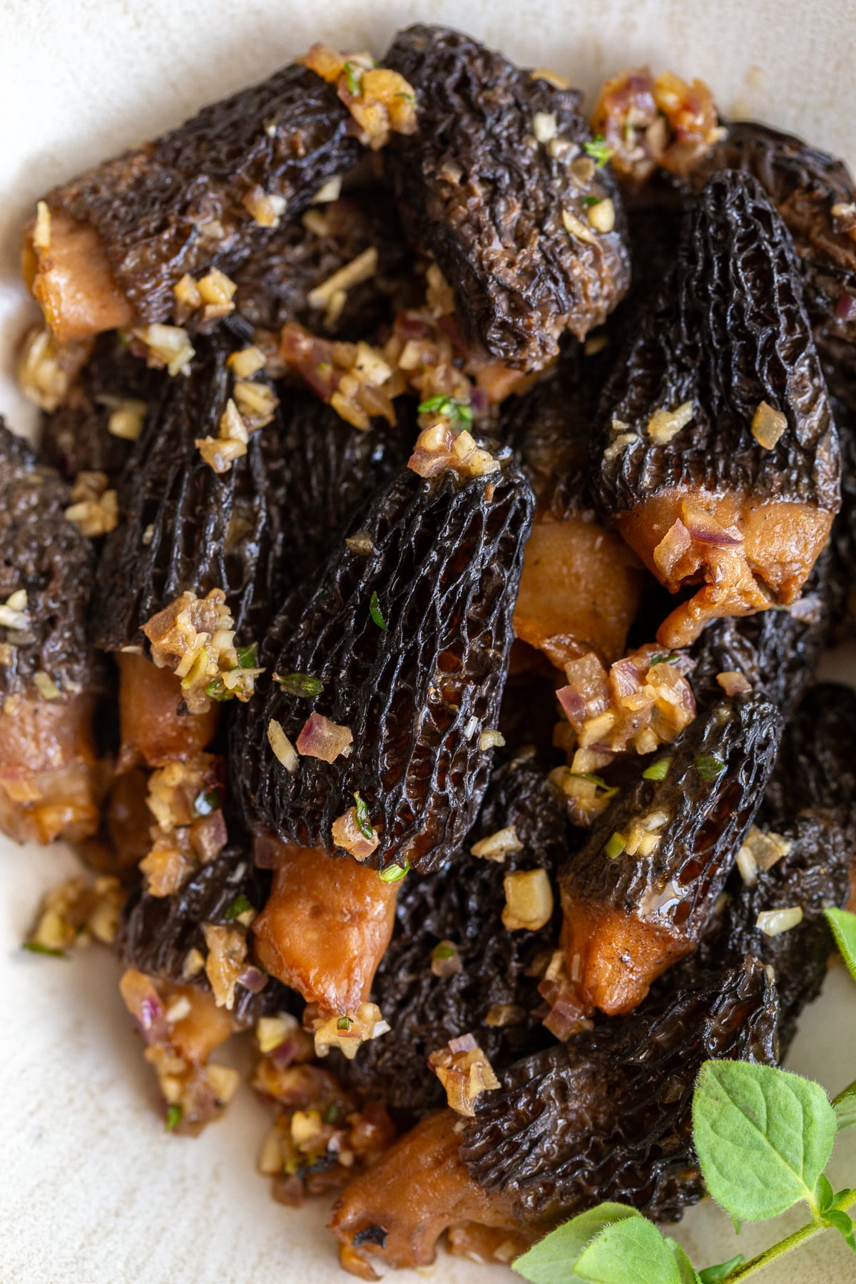 sauteed morel mushrooms in a bowl and topped with oregano