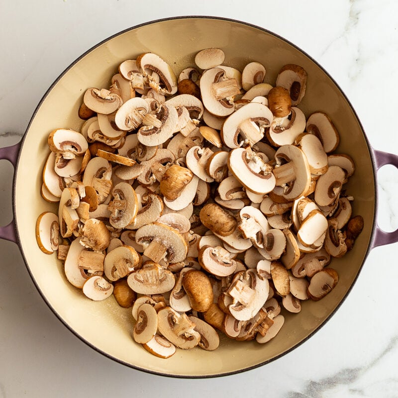 baby bella mushrooms in a skillet