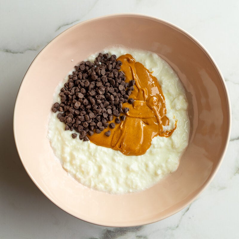 yogurt, peanut butter, and mini chocolate chips in a bowl to make yogurt bars