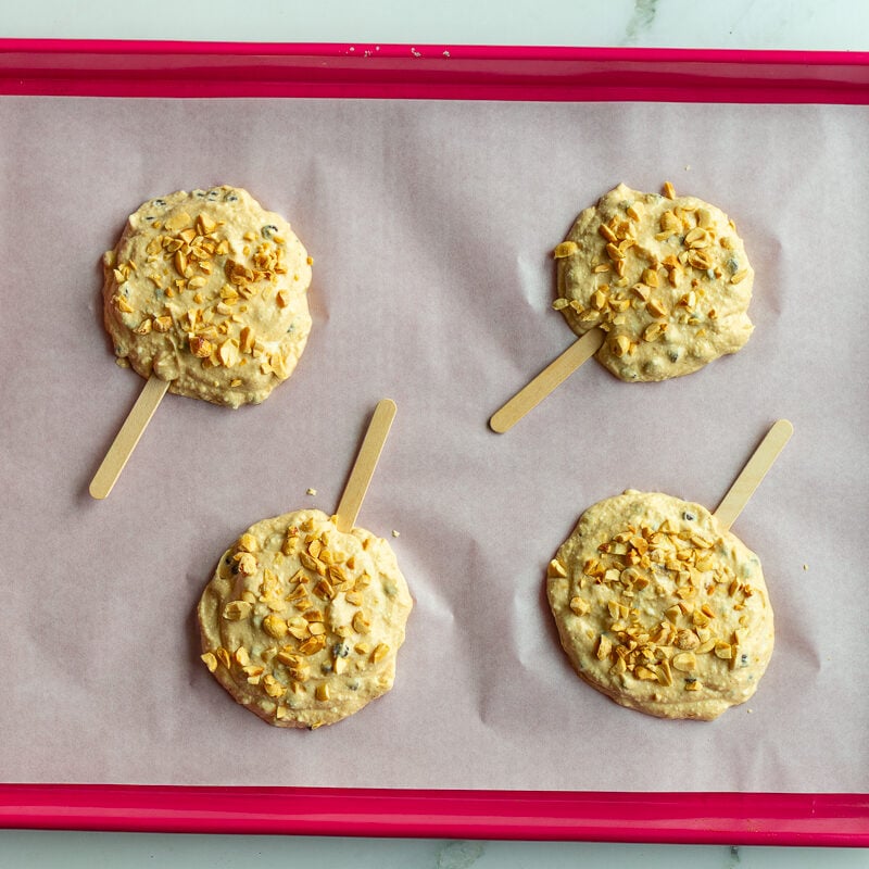 greek yogurt bars on a red baking sheet before they've been frozen