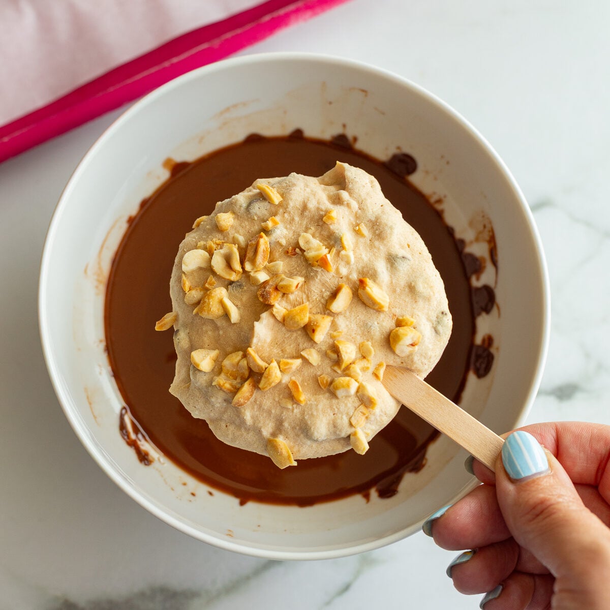 frozen yogurt bars before being dipped in a bowl of melted chocolate