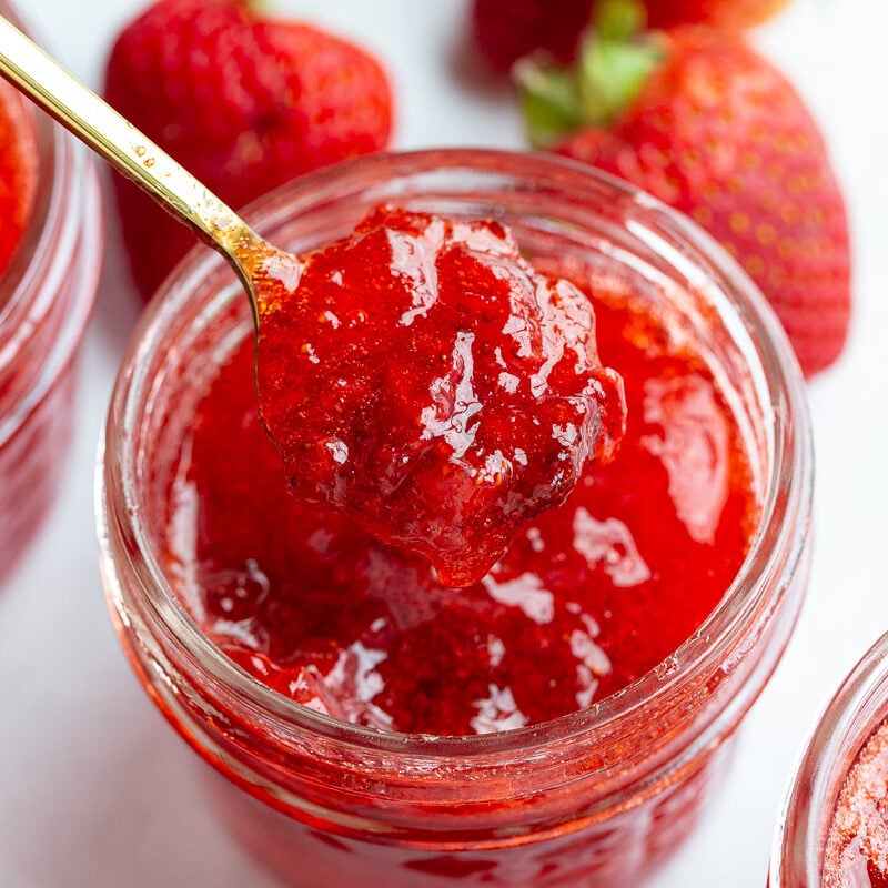 Spooning out strawberry jam.