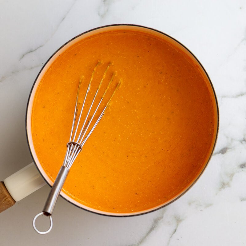 buffalo sauce whisked in a white pot