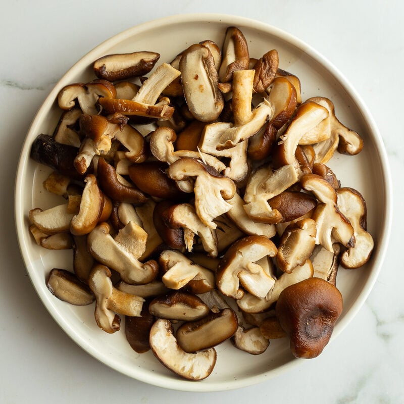 thinly sliced shiitake mushrooms on a plate
