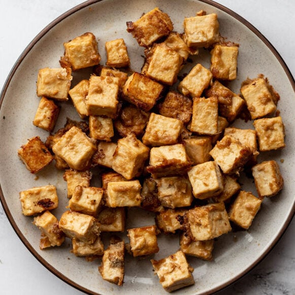 peanut sauce marinated tofu cubes on a plate