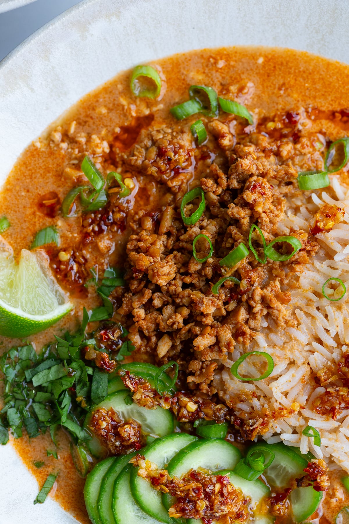 creamy vegetarian broth bowls with rice, tofu mince, and cucumbers