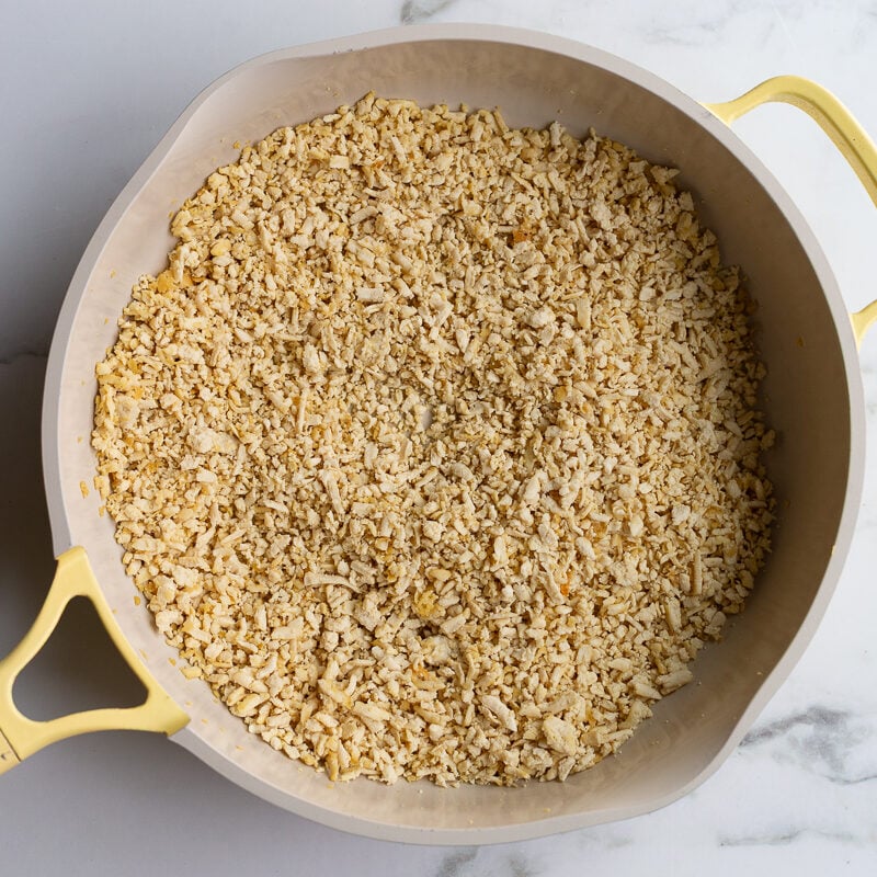 minced tofu crisped up in a yellow skillet