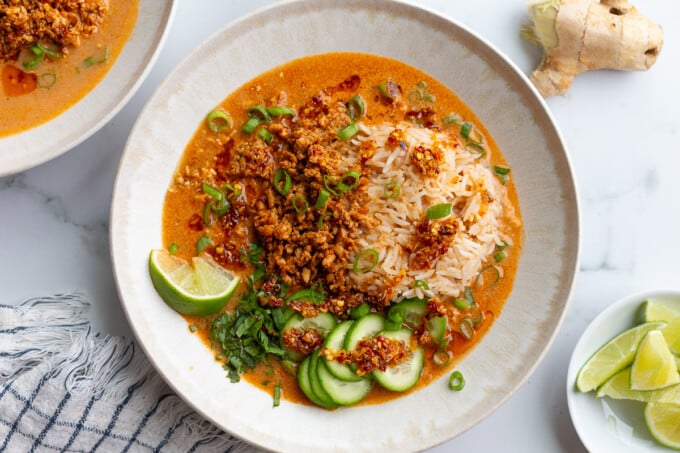 creamy vegetarian broth bowls with rice, tofu mince, and cucumbers